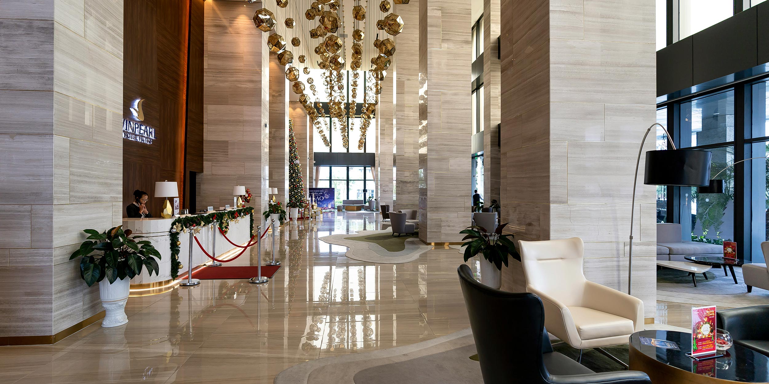 Elegant hotel lobby with festive décor and luxurious seating areas
