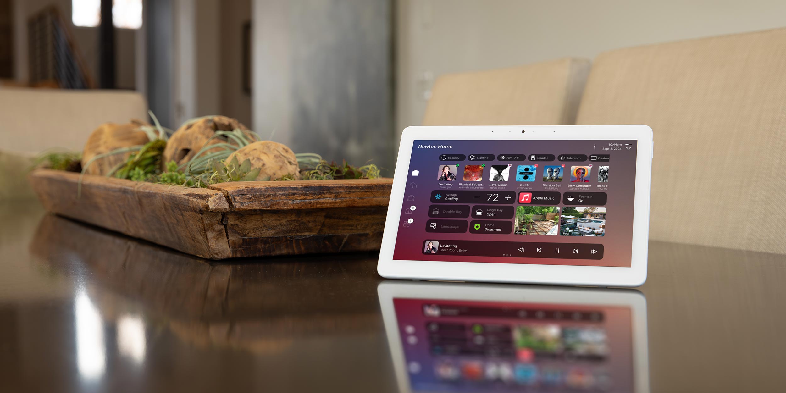 Smart home control tablet on dining table with music and lights